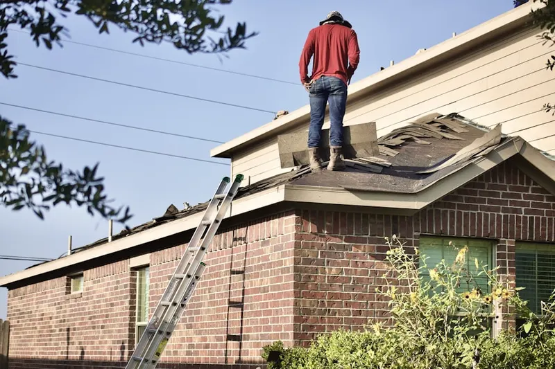 Professional roofer working on a residential roof in Lisbon Acres